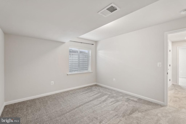 spare room with carpet flooring, baseboards, and a smoke detector