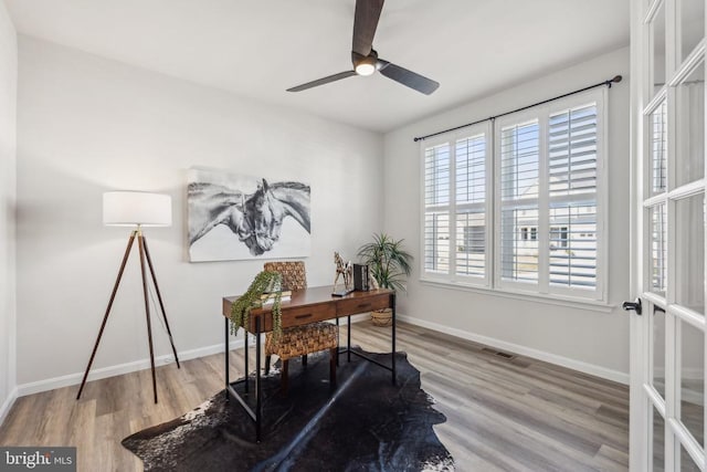 office space with wood finished floors, ceiling fan, and baseboards