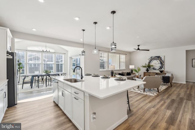 kitchen featuring a sink, appliances with stainless steel finishes, a ceiling fan, light wood-style floors, and recessed lighting