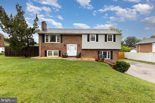 12016 Branchwater St, Fredericksburg, VA 22407 - bi-level home with brick siding, a chimney, and concrete driveway