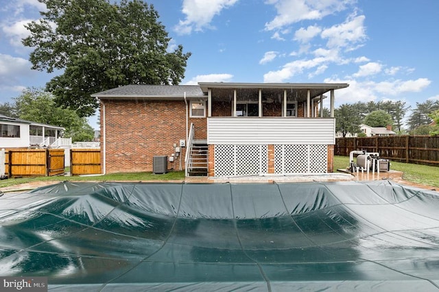 12016 Branchwater St, Fredericksburg, VA 22407 - rear view of house with brick siding, a sunroom, and stairs