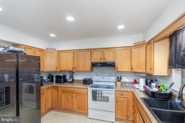 12016 Branchwater St, Fredericksburg, VA 22407 - kitchen with white range with electric stovetop, stainless steel fridge, a sink, under cabinet range hood, and recessed lighting