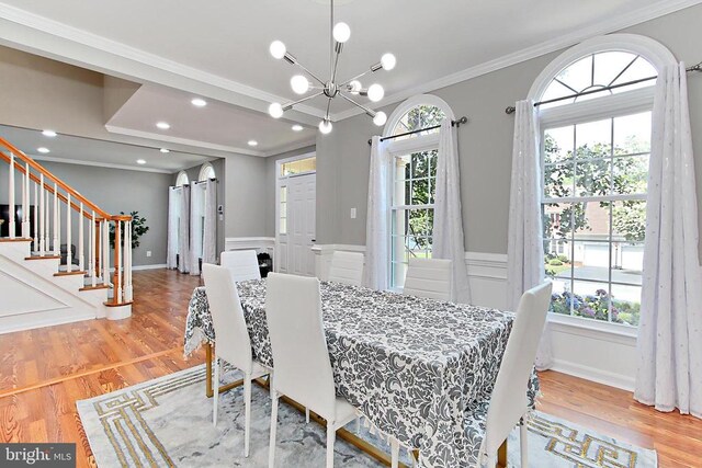 10409 Colechester St, Fredericksburg, VA 22408 - dining area featuring wainscoting, crown molding, a chandelier, wood finished floors, and a decorative wall