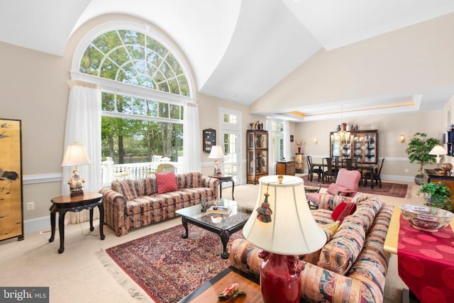 11306 Stonewall Jackson Dr, Spotsylvania, VA 22551 - carpeted living room featuring high vaulted ceiling and a chandelier