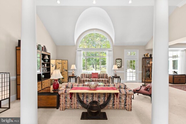 11306 Stonewall Jackson Dr, Spotsylvania, VA 22551 - carpeted living room with vaulted ceiling and decorative columns