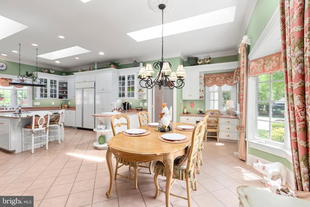 11306 Stonewall Jackson Dr, Spotsylvania, VA 22551 - dining space with a skylight, crown molding, a chandelier, healthy amount of natural light, and light tile patterned flooring