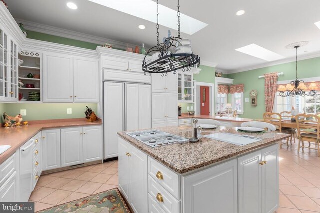 11306 Stonewall Jackson Dr, Spotsylvania, VA 22551 - kitchen with a chandelier, a skylight, white gas cooktop, ornamental molding, and light tile patterned floors