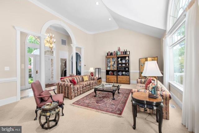 11306 Stonewall Jackson Dr, Spotsylvania, VA 22551 - carpeted living area with arched walkways, high vaulted ceiling, decorative columns, and a chandelier