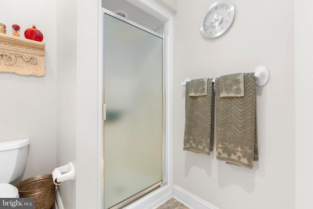 11306 Stonewall Jackson Dr, Spotsylvania, VA 22551 - full bathroom featuring a stall shower, toilet, and baseboards