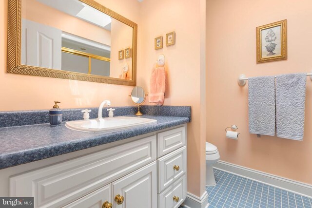 11306 Stonewall Jackson Dr, Spotsylvania, VA 22551 - bathroom with tile patterned flooring, vanity, and toilet