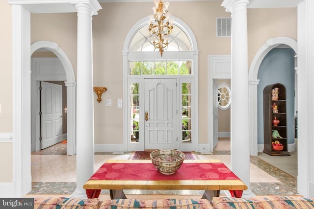 11306 Stonewall Jackson Dr, Spotsylvania, VA 22551 - entryway with a towering ceiling, decorative columns, arched walkways, and light tile patterned floors