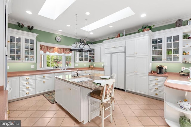 11306 Stonewall Jackson Dr, Spotsylvania, VA 22551 - kitchen featuring a skylight, paneled built in fridge, white cabinets, ornamental molding, and open shelves
