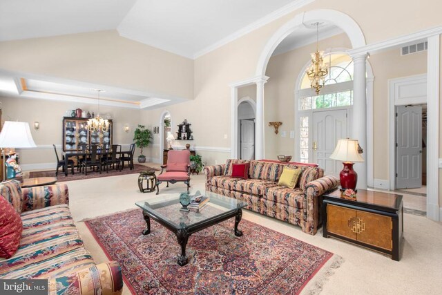 11306 Stonewall Jackson Dr, Spotsylvania, VA 22551 - carpeted living room featuring arched walkways, a chandelier, decorative columns, and ornamental molding