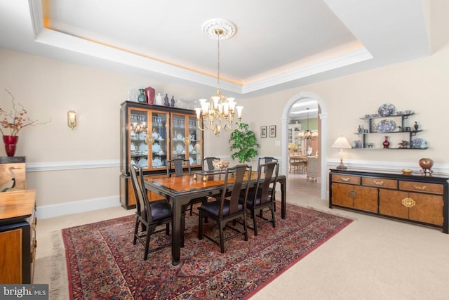 11306 Stonewall Jackson Dr, Spotsylvania, VA 22551 - dining room featuring a raised ceiling, a chandelier, arched walkways, and light carpet