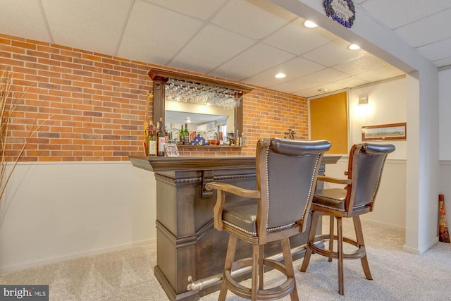 47 Marwood Dr, Palmyra, VA 22963 - bar with a paneled ceiling, brick wall, a bar, and carpet