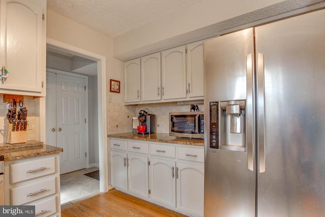 47 Marwood Dr, Palmyra, VA 22963 - kitchen with white cabinets, stainless steel appliances, light wood-style flooring, and backsplash