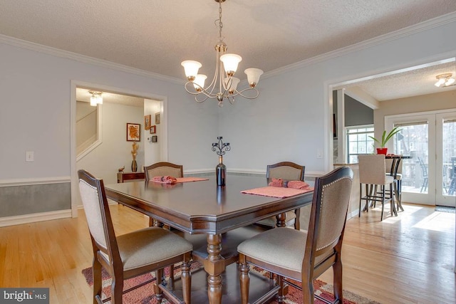 47 Marwood Dr, Palmyra, VA 22963 - dining area featuring an inviting chandelier, crown molding, a textured ceiling, baseboards, and light wood-style floors