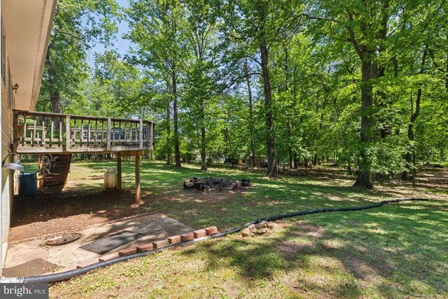  - view of green lawn featuring a deck