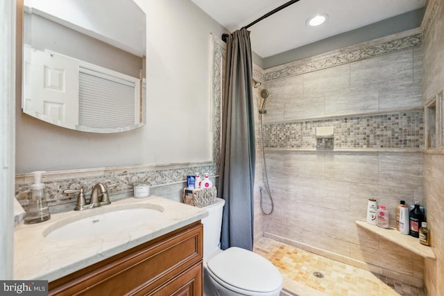  - full bathroom with a tile shower, vanity, and toilet