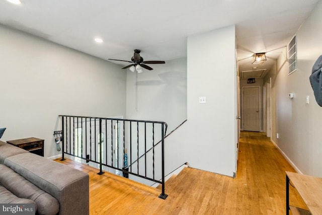  - hallway featuring attic access, an upstairs landing, wood finished floors, baseboards, and recessed lighting