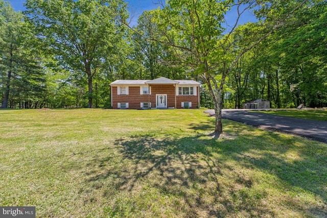  - view of front facade with a front yard and driveway