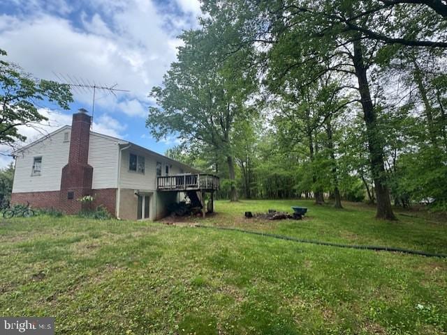 view of grassy yard featuring a wooden deck