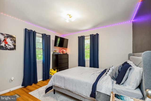  - bedroom with light wood-style flooring and baseboards