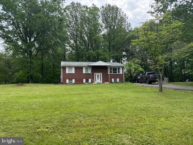 raised ranch with a front yard