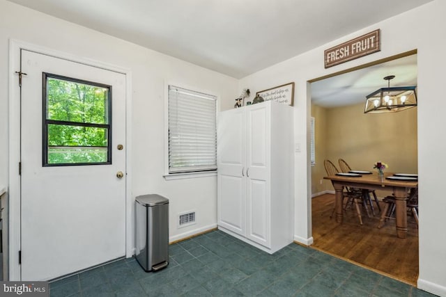  - interior space with a chandelier and baseboards