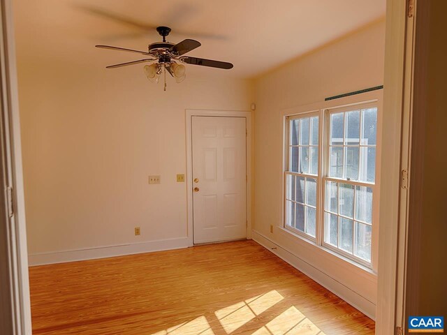 unfurnished room featuring ceiling fan, a healthy amount of sunlight, and light wood-type flooring