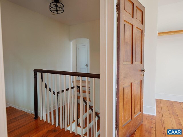 stairs featuring hardwood / wood-style flooring