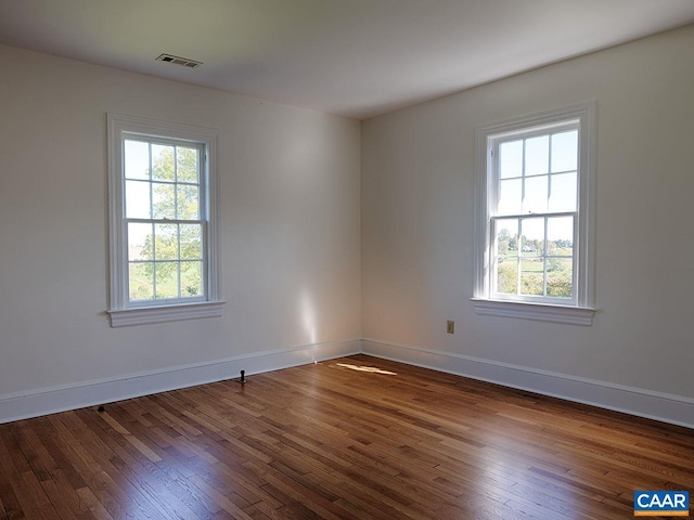 spare room featuring dark hardwood / wood-style floors