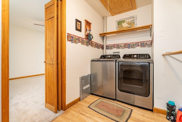 17962 Old Barn Ln, Elkton, VA 22827 - washroom featuring washer and clothes dryer, attic access, and light wood-style floors