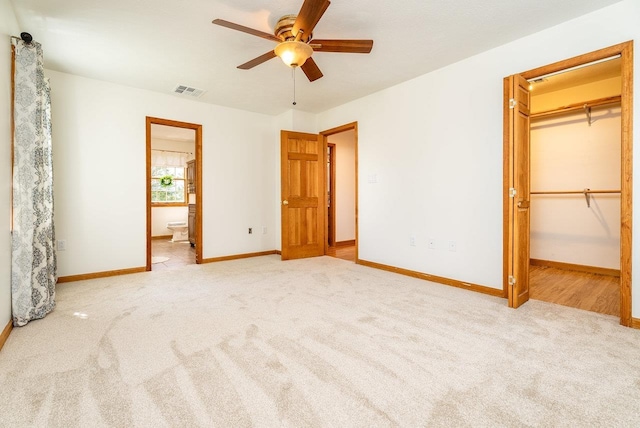 17962 Old Barn Ln, Elkton, VA 22827 - unfurnished bedroom featuring carpet floors, a spacious closet, ensuite bath, and ceiling fan