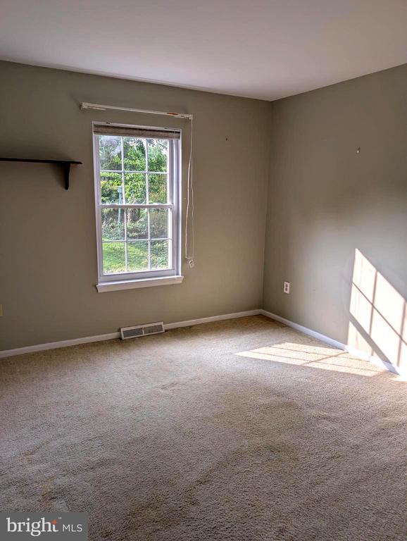  - spare room with baseboards and carpet
