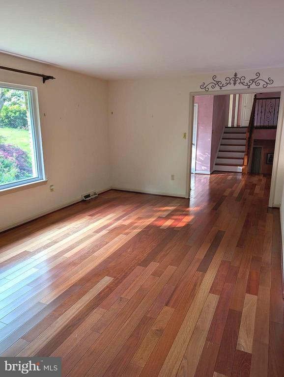  - unfurnished room featuring hardwood / wood-style floors and stairs