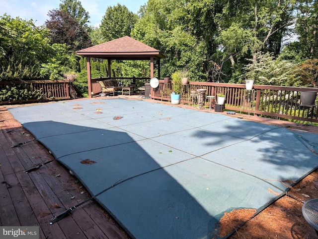  - view of swimming pool with a gazebo and a wooden deck