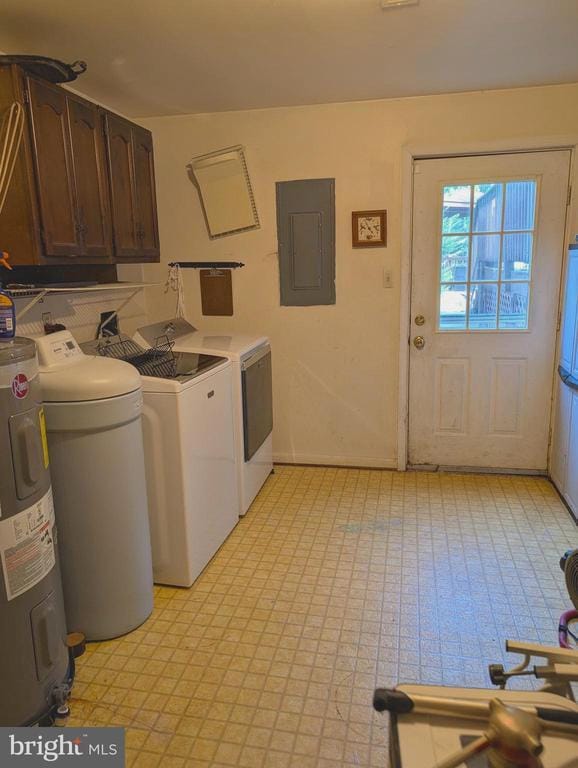  - laundry room featuring washer and clothes dryer, cabinet space, electric panel, light flooring, and electric water heater