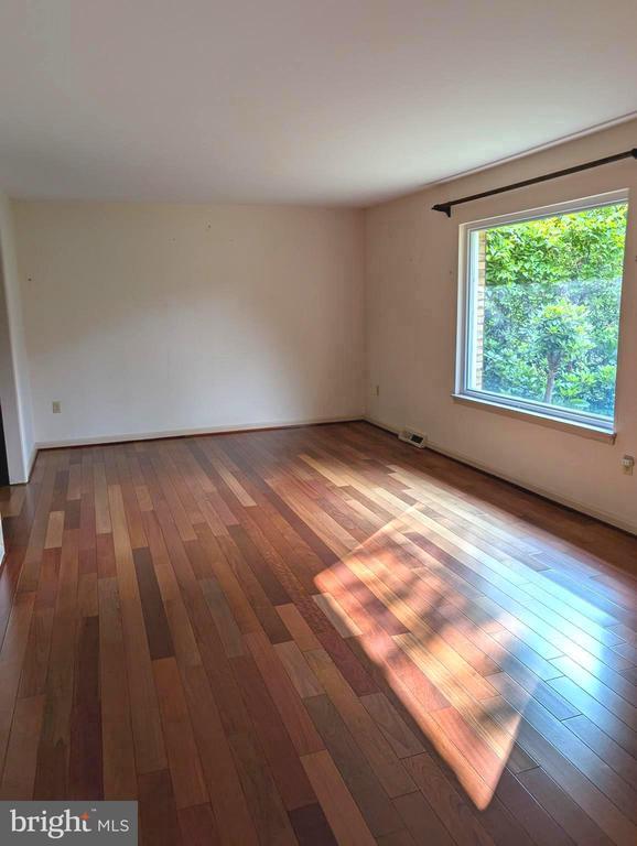  - spare room featuring hardwood / wood-style floors