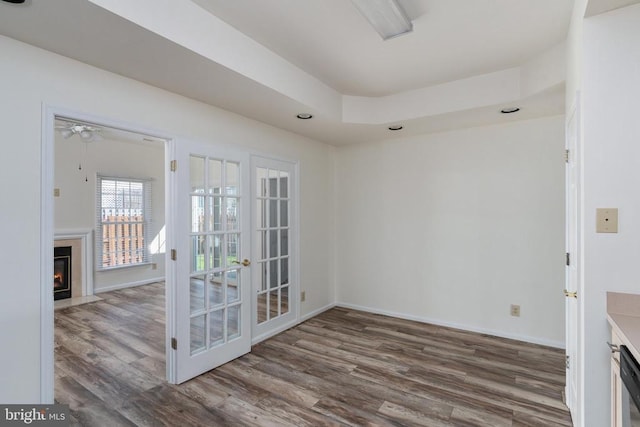 11120 Dragons Lair Dr, Fredericksburg, VA 22407 - empty room featuring a fireplace with flush hearth, wood finished floors, french doors, a ceiling fan, and recessed lighting