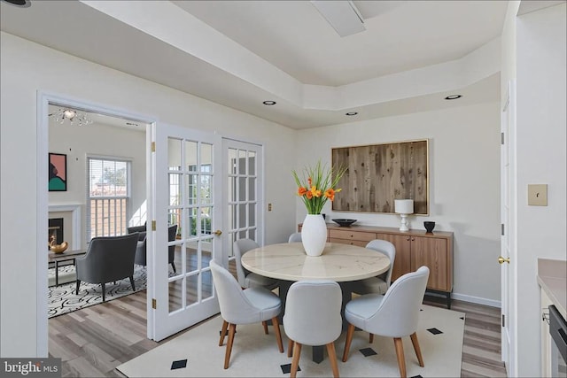 11120 Dragons Lair Dr, Fredericksburg, VA 22407 - dining area with light wood-type flooring and a warm lit fireplace