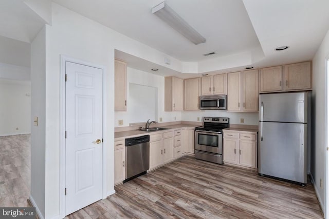 11120 Dragons Lair Dr, Fredericksburg, VA 22407 - kitchen featuring appliances with stainless steel finishes, light countertops, light brown cabinets, and wood finished floors