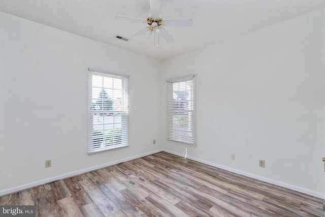 11120 Dragons Lair Dr, Fredericksburg, VA 22407 - unfurnished room featuring healthy amount of natural light, wood finished floors, and ceiling fan