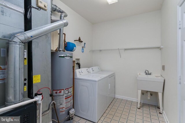 11120 Dragons Lair Dr, Fredericksburg, VA 22407 - washroom featuring gas water heater, washing machine and clothes dryer, light tile patterned flooring, and heating unit