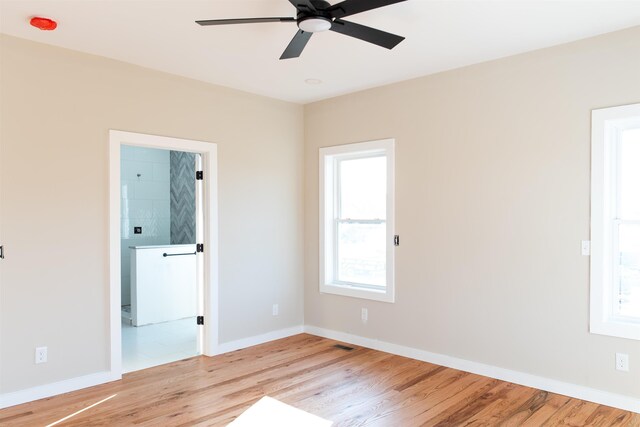 empty room featuring ceiling fan and light hardwood / wood-style floors