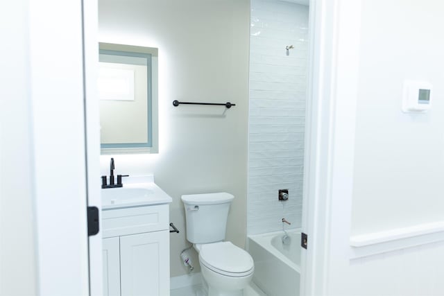 full bathroom featuring vanity, tiled shower / bath, and toilet