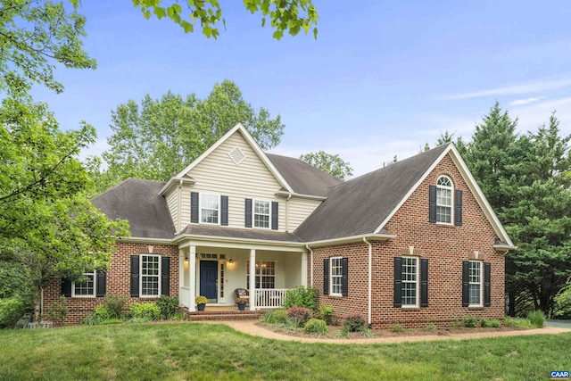2005 Bentivar Dr, Charlottesville, VA 22911 - traditional-style house with a porch, brick siding, a front yard, and a shingled roof
