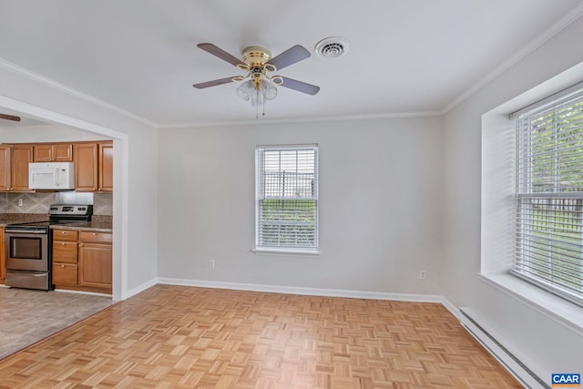 kitchen with electric stove, a baseboard radiator, white microwave, ceiling fan, and plenty of natural light