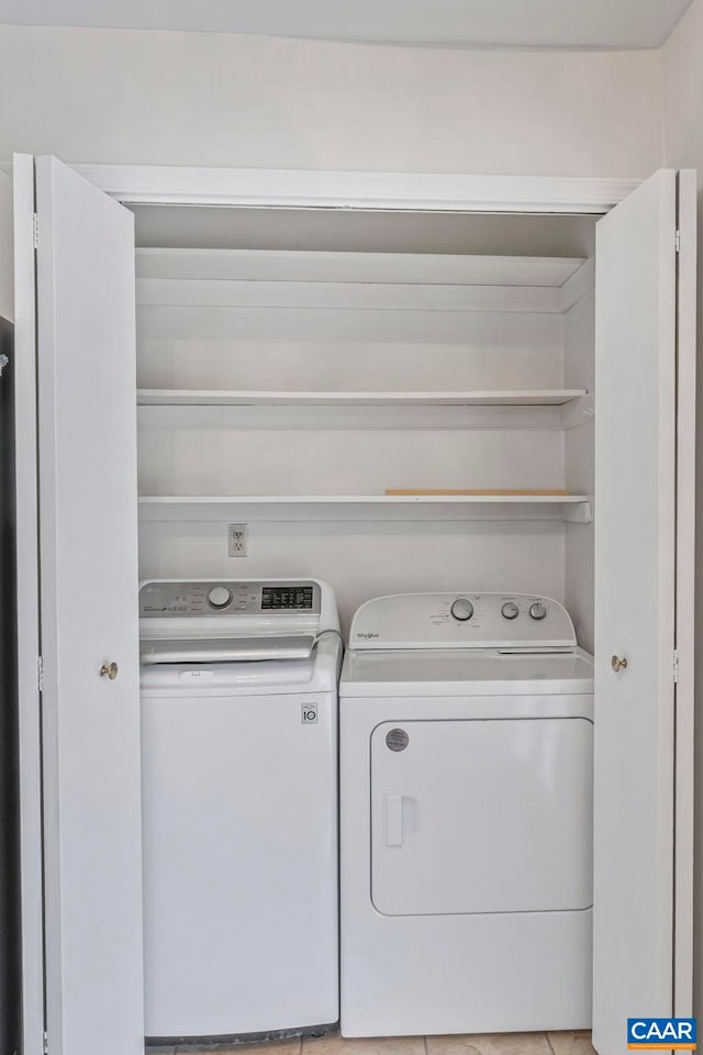 clothes washing area with washing machine and dryer