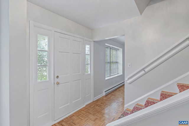 entrance foyer with a baseboard heating unit and stairs